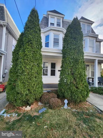 a view of a house with a yard and plants