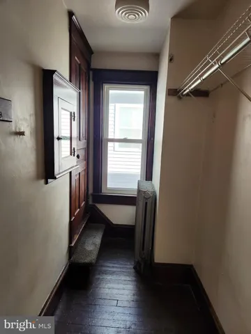 a room with wooden floor and furniture