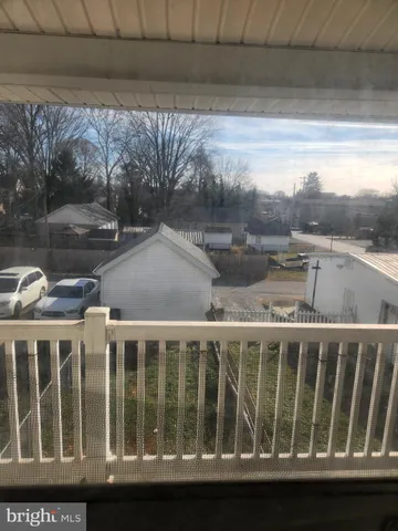 a view of balcony with a yard