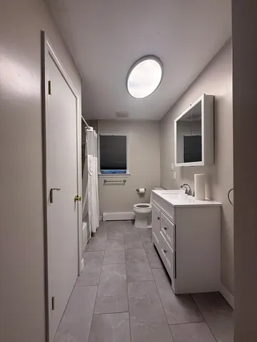 a bathroom with a shower curtain and a sink