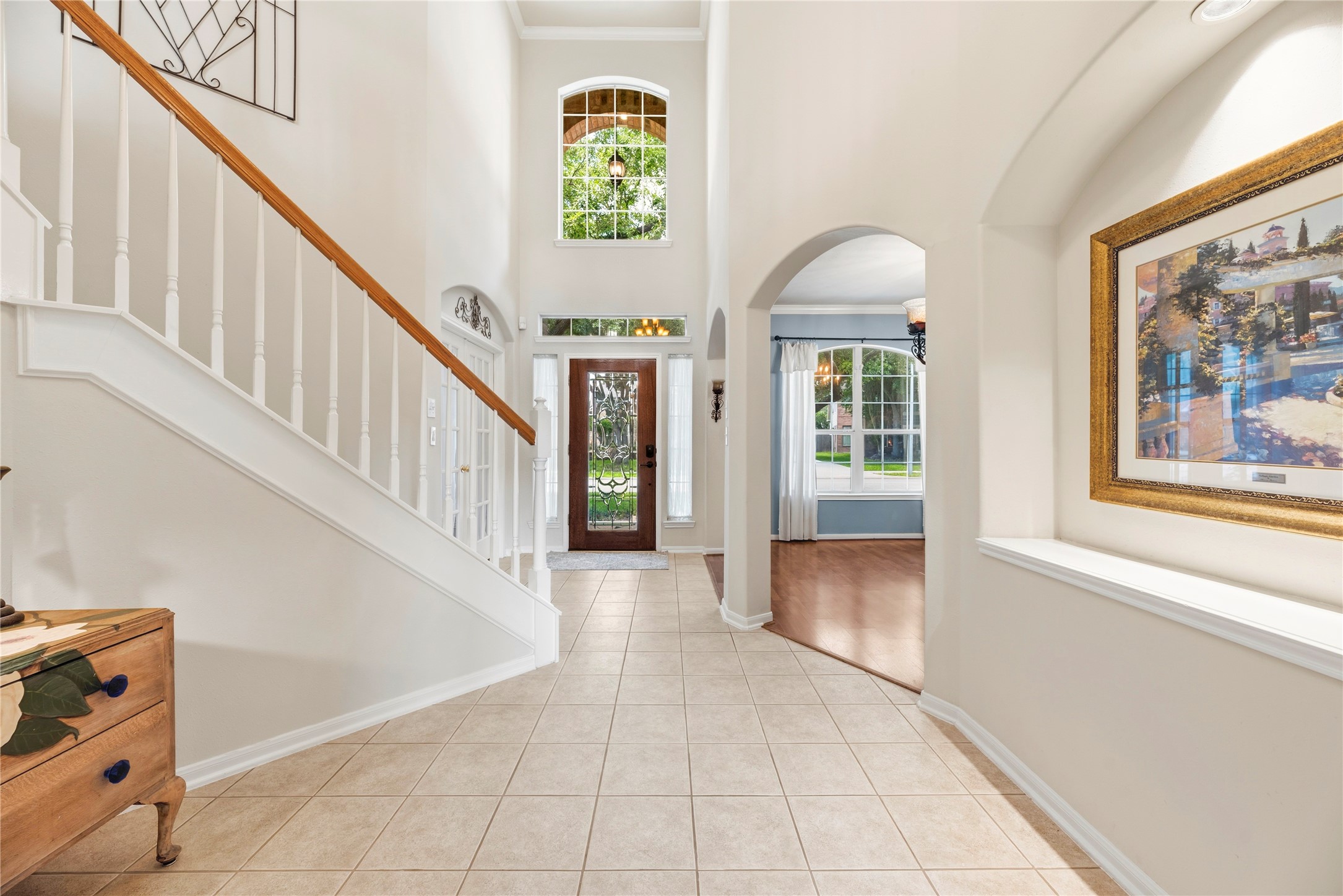 7930 Chateau Point Lane Houston, TX 77041 - Photo 8 of 34 This welcoming foyer features high ceilings, a beautiful staircase, and elegant tile flooring. Natural light floods in through large windows and a glass front door. The hallway leads into an open living area, perfect for entertaining.
