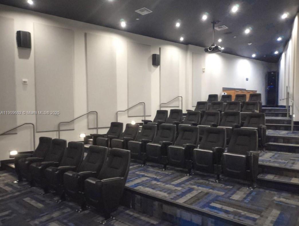 2950 Northeast 188th Street, Unit 501 Aventura, FL 33180 - Photo 13 of 46 a media room with lots of chairs and a projector screen