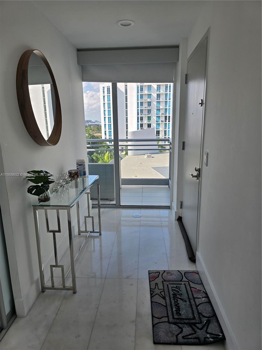 2950 Northeast 188th Street, Unit 501 Aventura, FL 33180 - Photo 17 of 46 a view of a entryway door and an outdoor space