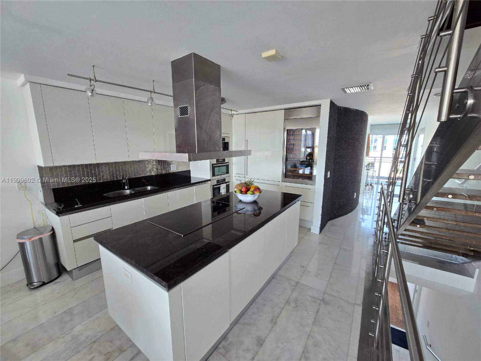 2950 Northeast 188th Street, Unit 501 Aventura, FL 33180 - Photo 21 of 46 a kitchen with granite countertop a stove and a refrigerator