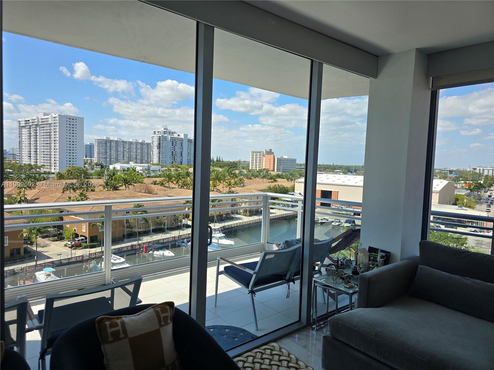 2950 Northeast 188th Street, Unit 501 Aventura, FL 33180 - Photo 24 of 46 a living room with furniture and a floor to ceiling window