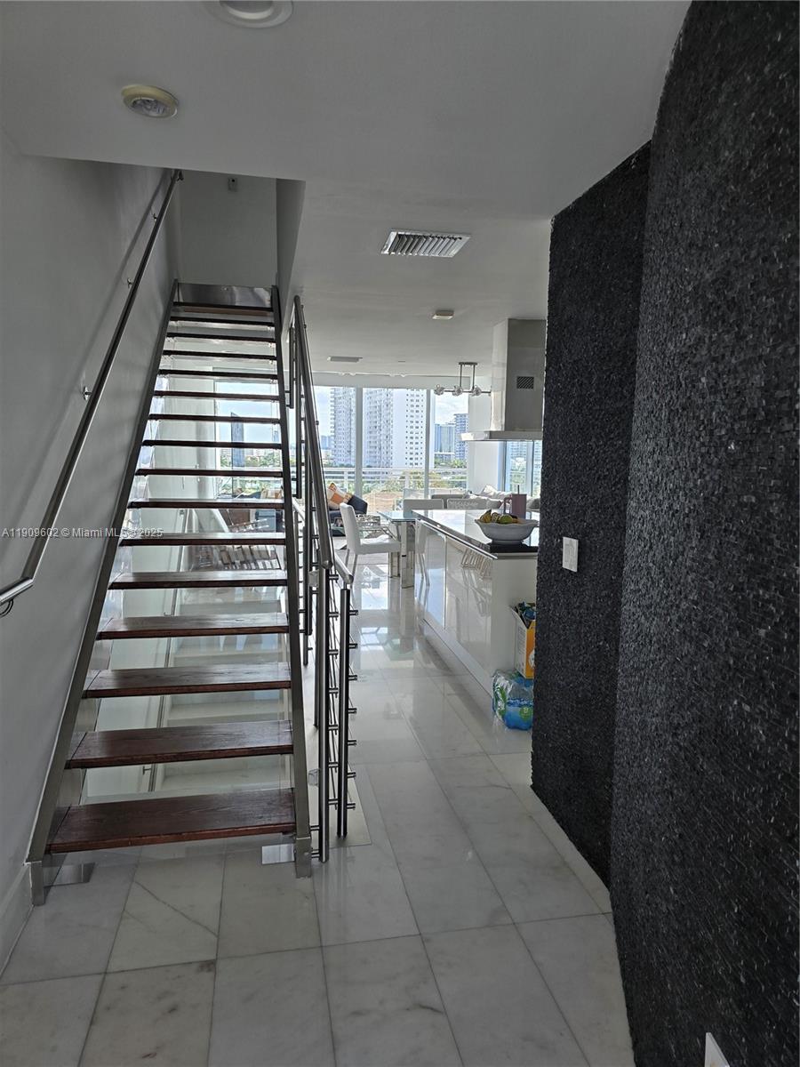 2950 Northeast 188th Street, Unit 501 Aventura, FL 33180 - Photo 27 of 46 a kitchen with a refrigerator and window