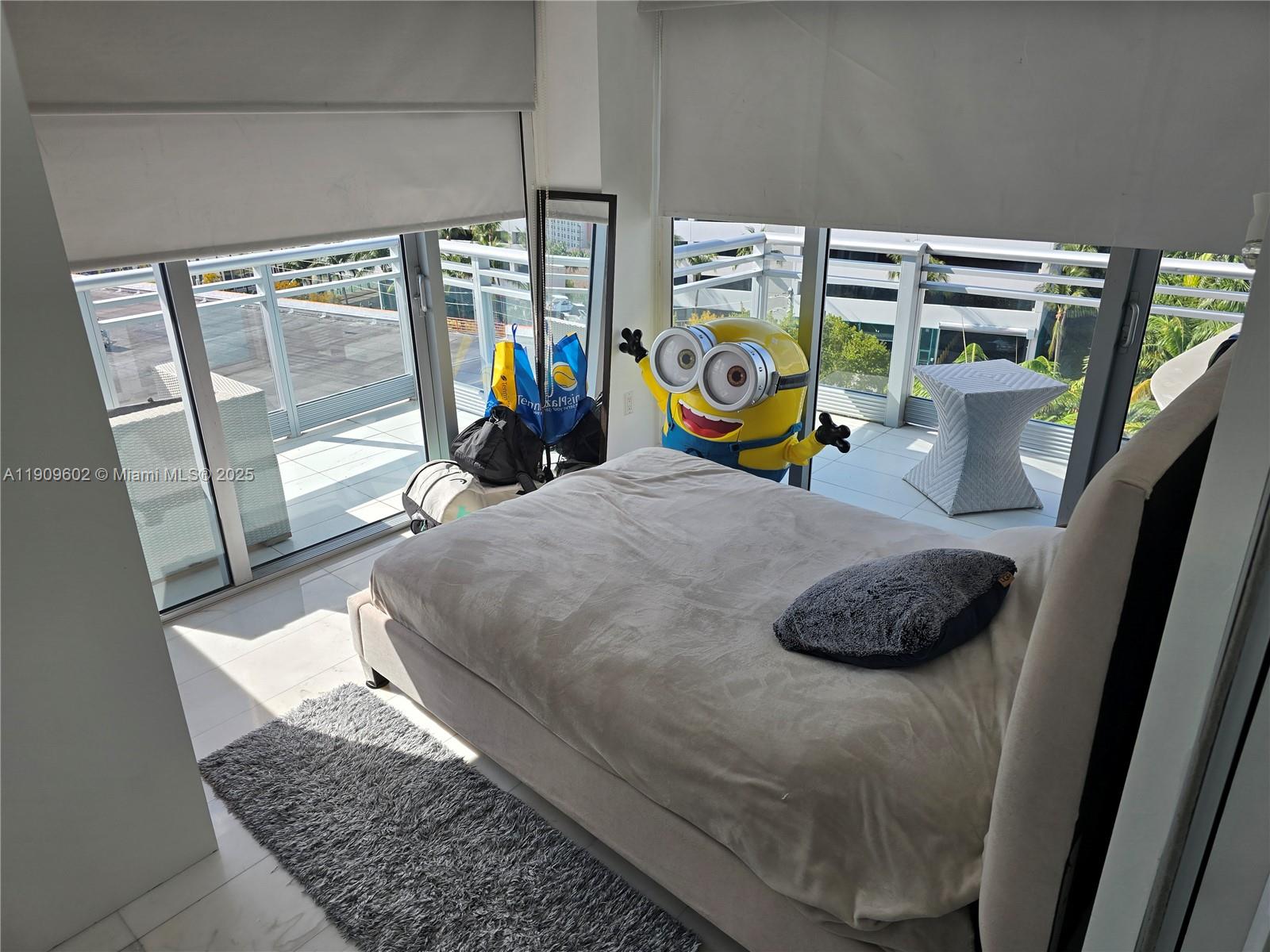 2950 Northeast 188th Street, Unit 501 Aventura, FL 33180 - Photo 29 of 46 a bedroom with bed and sliding door