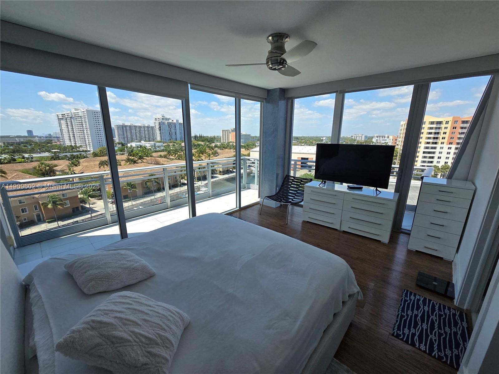 2950 Northeast 188th Street, Unit 501 Aventura, FL 33180 - Photo 34 of 46 a bedroom with a bed and wooden floor