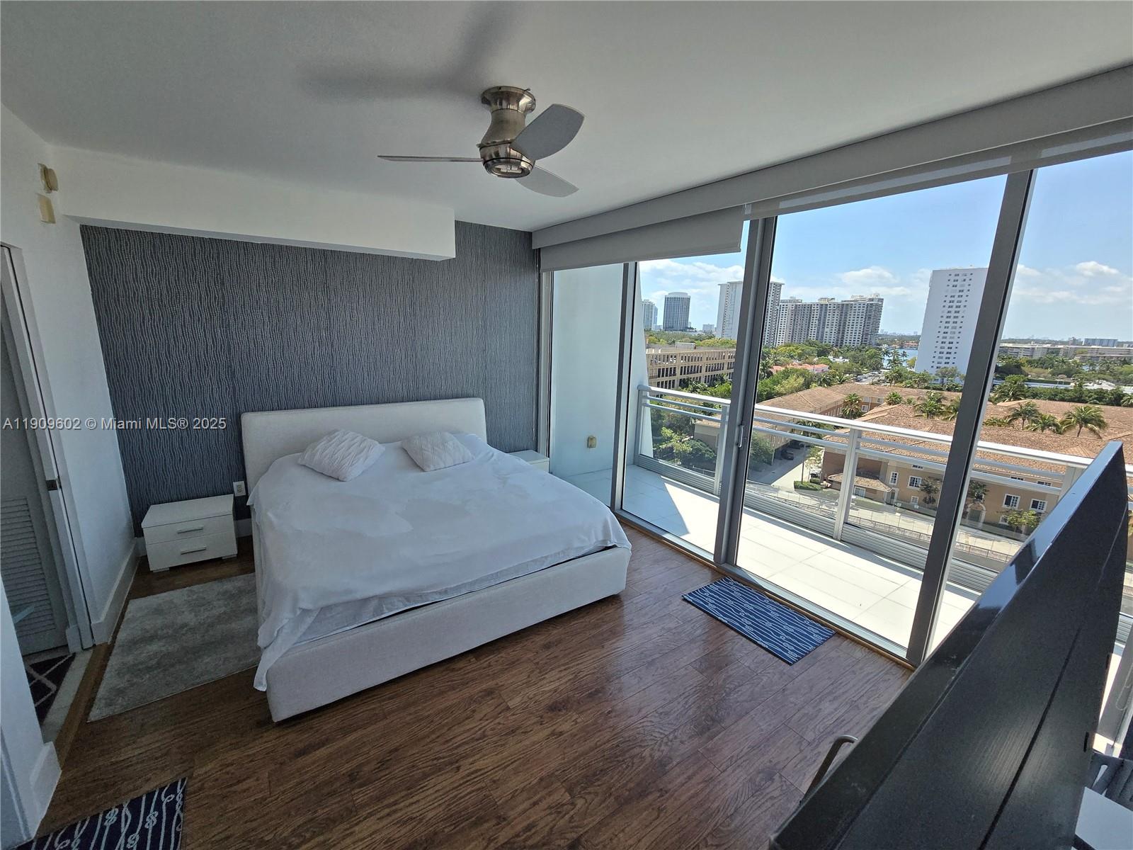 2950 Northeast 188th Street, Unit 501 Aventura, FL 33180 - Photo 35 of 46 a bedroom with a large bed and a large window