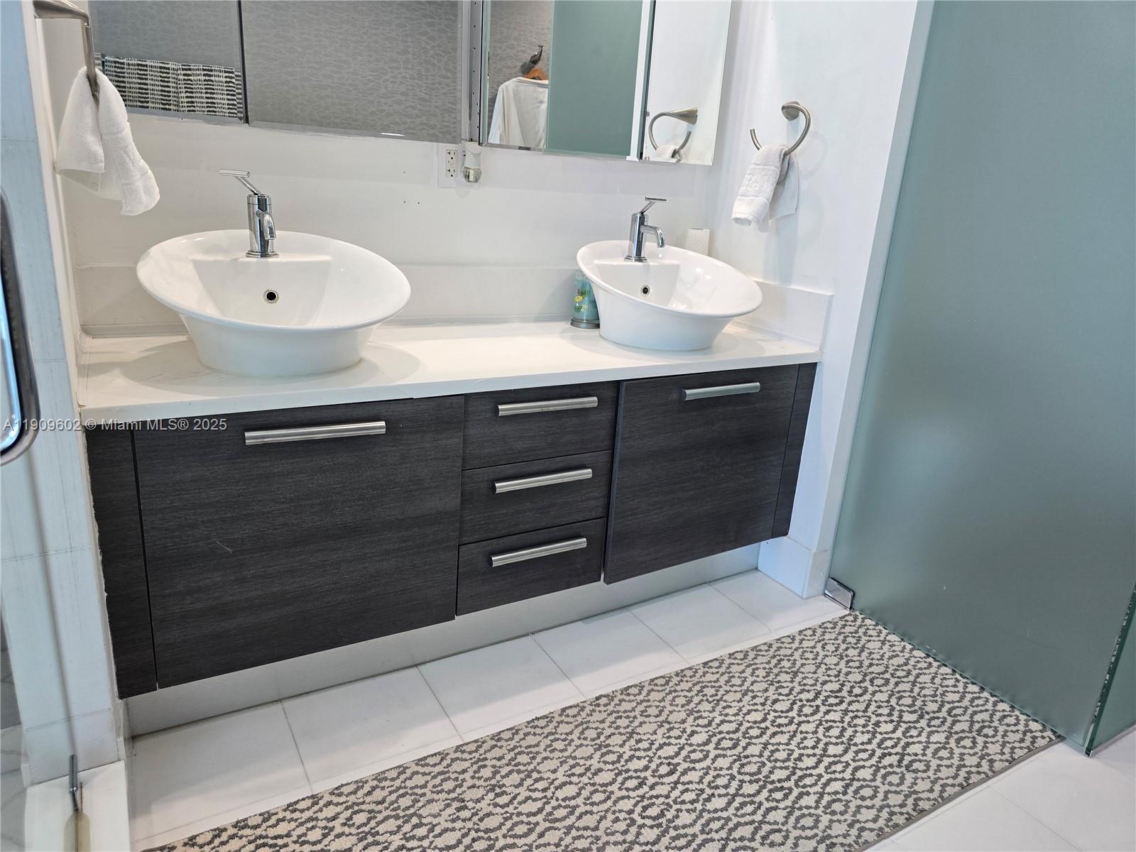 2950 Northeast 188th Street, Unit 501 Aventura, FL 33180 - Photo 37 of 46 a bathroom with a sink and a mirror