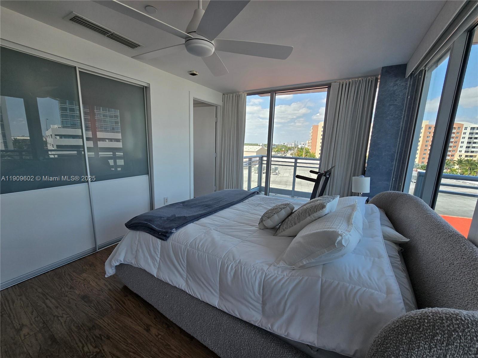 2950 Northeast 188th Street, Unit 501 Aventura, FL 33180 - Photo 40 of 46 a bedroom with a bed and a large window