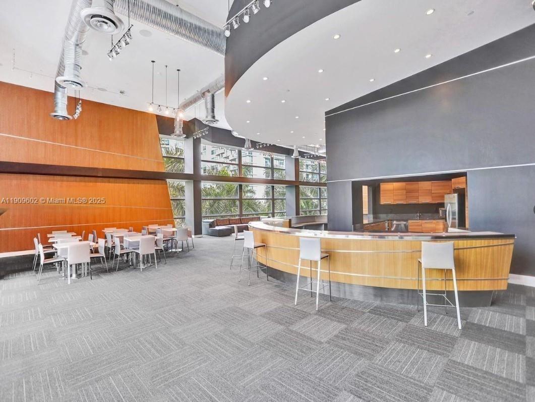 2950 Northeast 188th Street, Unit 501 Aventura, FL 33180 - Photo 5 of 46 a living room with furniture and a flat screen tv