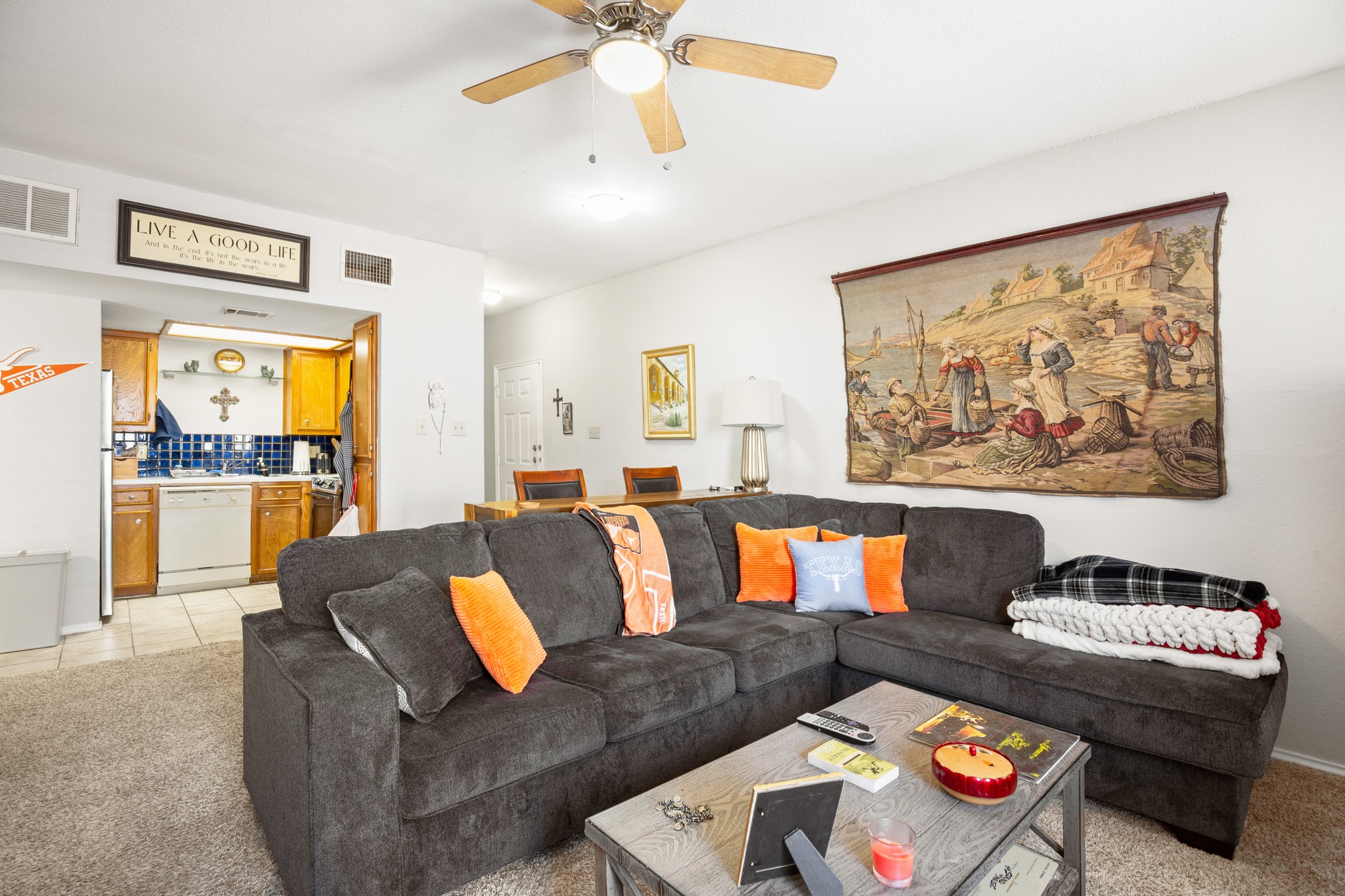 706 West 22nd Street, Unit 206 Austin, TX 78705 - Photo 3 of 18 Living room featuring light colored carpet, ceiling fan, and light tile patterned floors