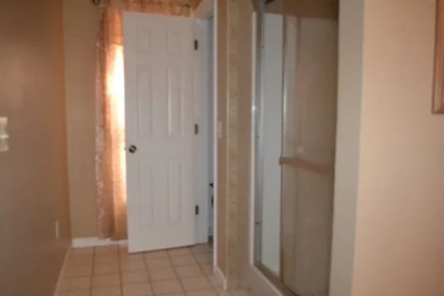 a bathroom with a granite countertop shower a toilet and a sink