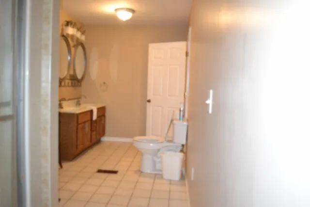 a bedroom with a bed and a night stand