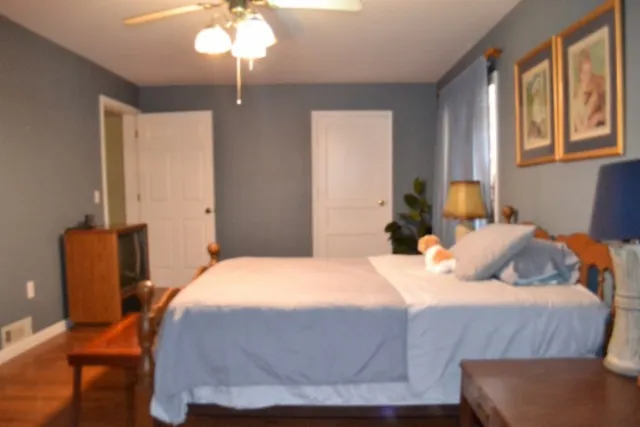 a bedroom with a bed and a chandelier