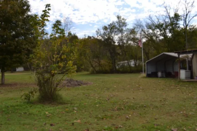 a view of a barn in the middle of a yard