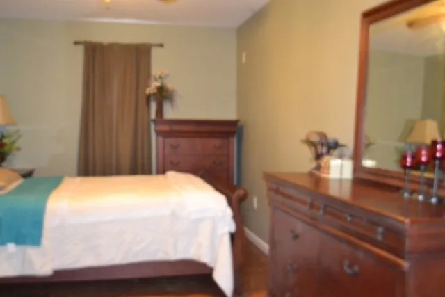 a bedroom with a bed and a potted plant