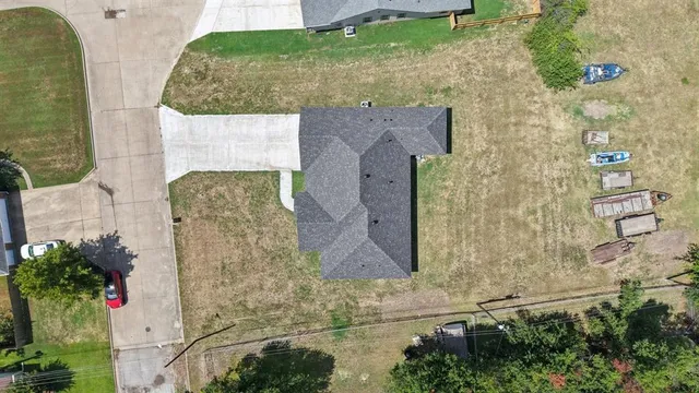 an aerial view of a house with a yard