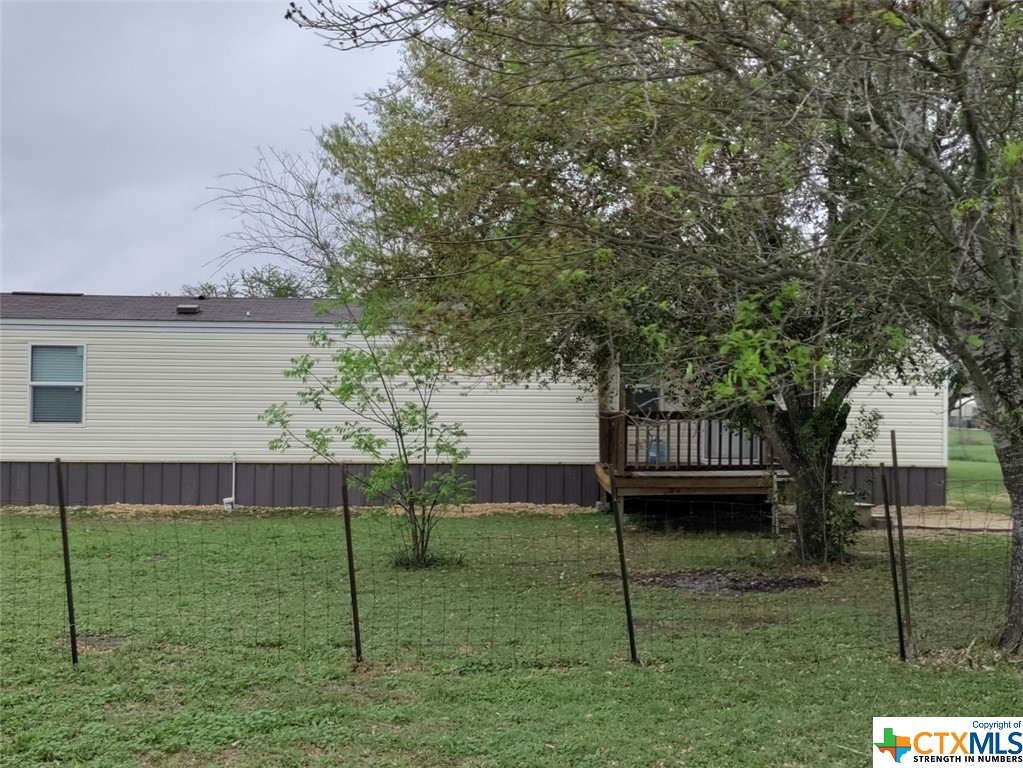 a view of a house with a backyard and a deck