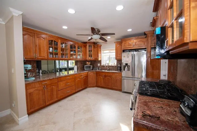 a kitchen with granite countertop a sink and cabinets
