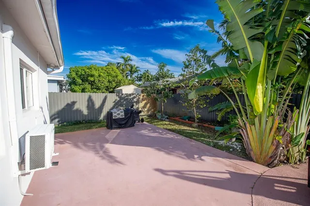 an aerial view of a house with a yard and furniture