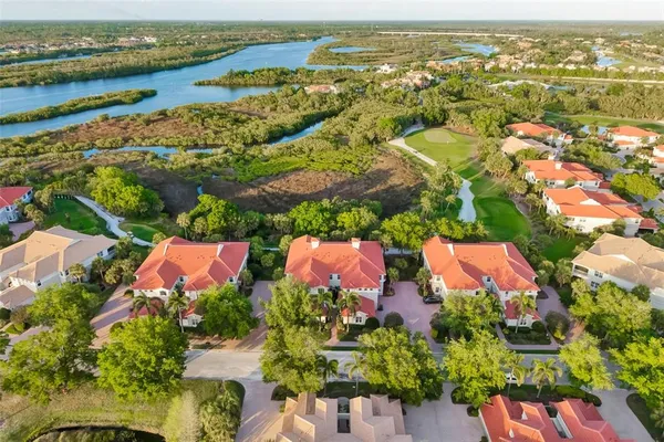 an aerial view of residential houses with outdoor space and river