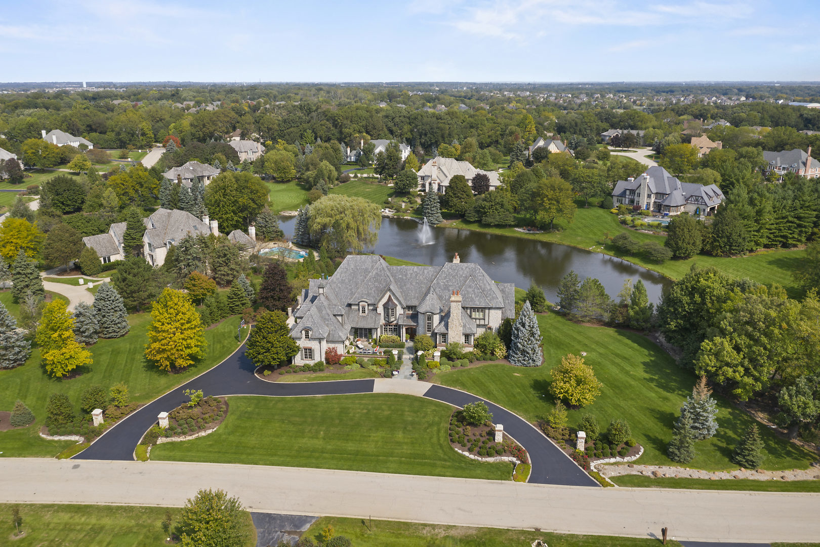an aerial view of a house with a lake view