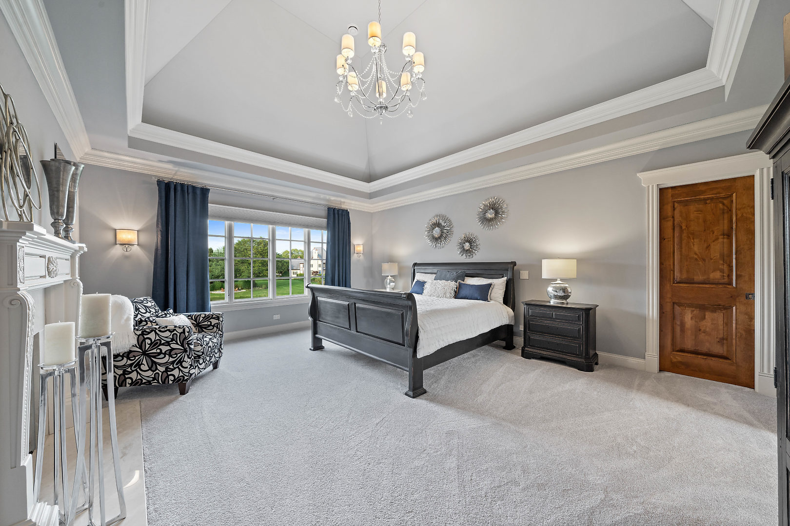 36W516 Hunters Gate Road St. Charles, IL 60175 - Photo 30 of 47 a spacious bedroom with a bed and a chandelier