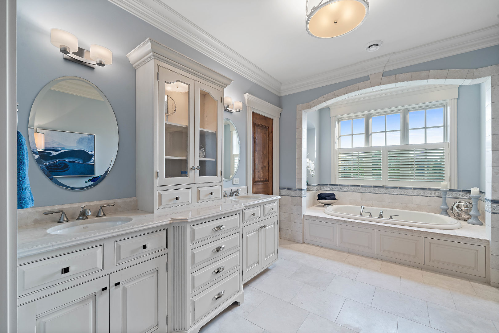 36W516 Hunters Gate Road St. Charles, IL 60175 - Photo 31 of 47 a spacious bathroom with a double vanity sink a large mirror and a bathtub with shower