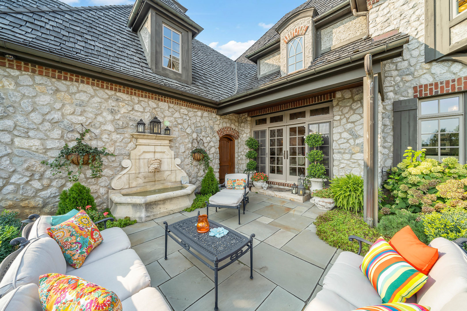 36W516 Hunters Gate Road St. Charles, IL 60175 - Photo 41 of 47 a view of a patio with couches table and chairs and potted plants