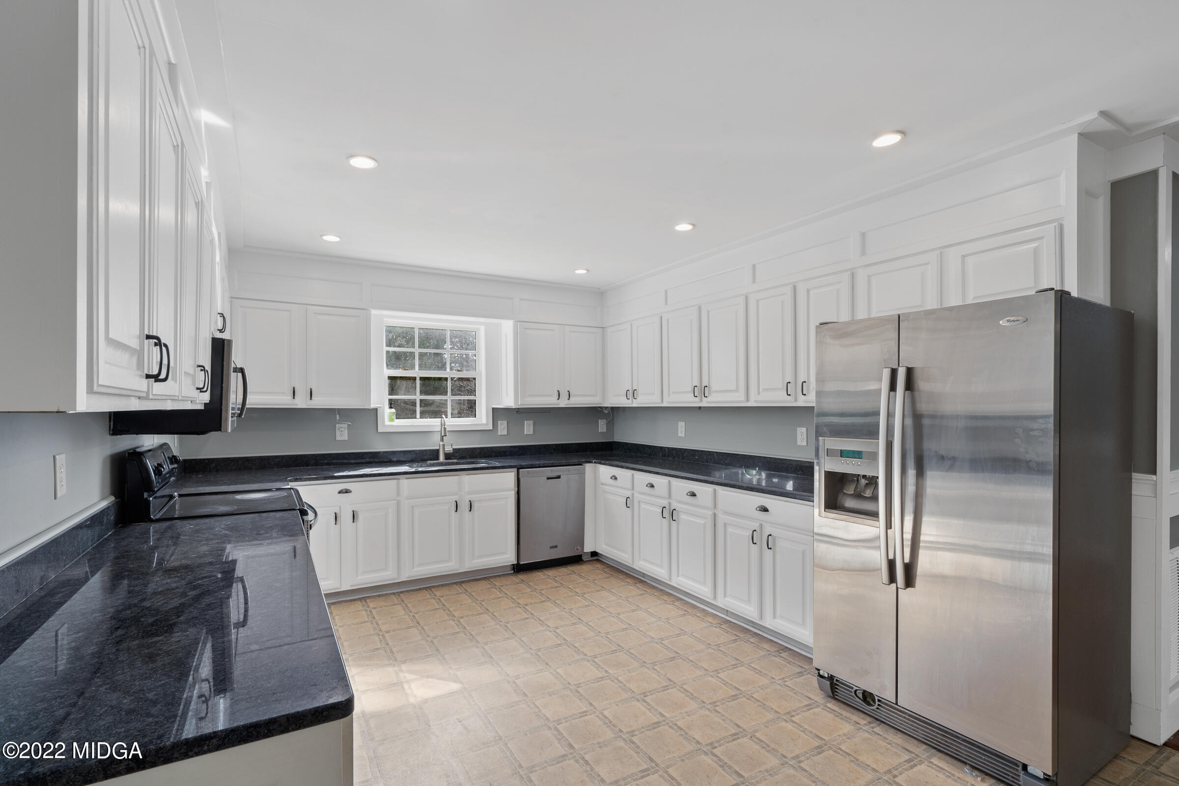 245 Lite-N-Tie Road Gray, GA 31032 - Photo 13 of 29 a kitchen with granite countertop a refrigerator and white cabinets