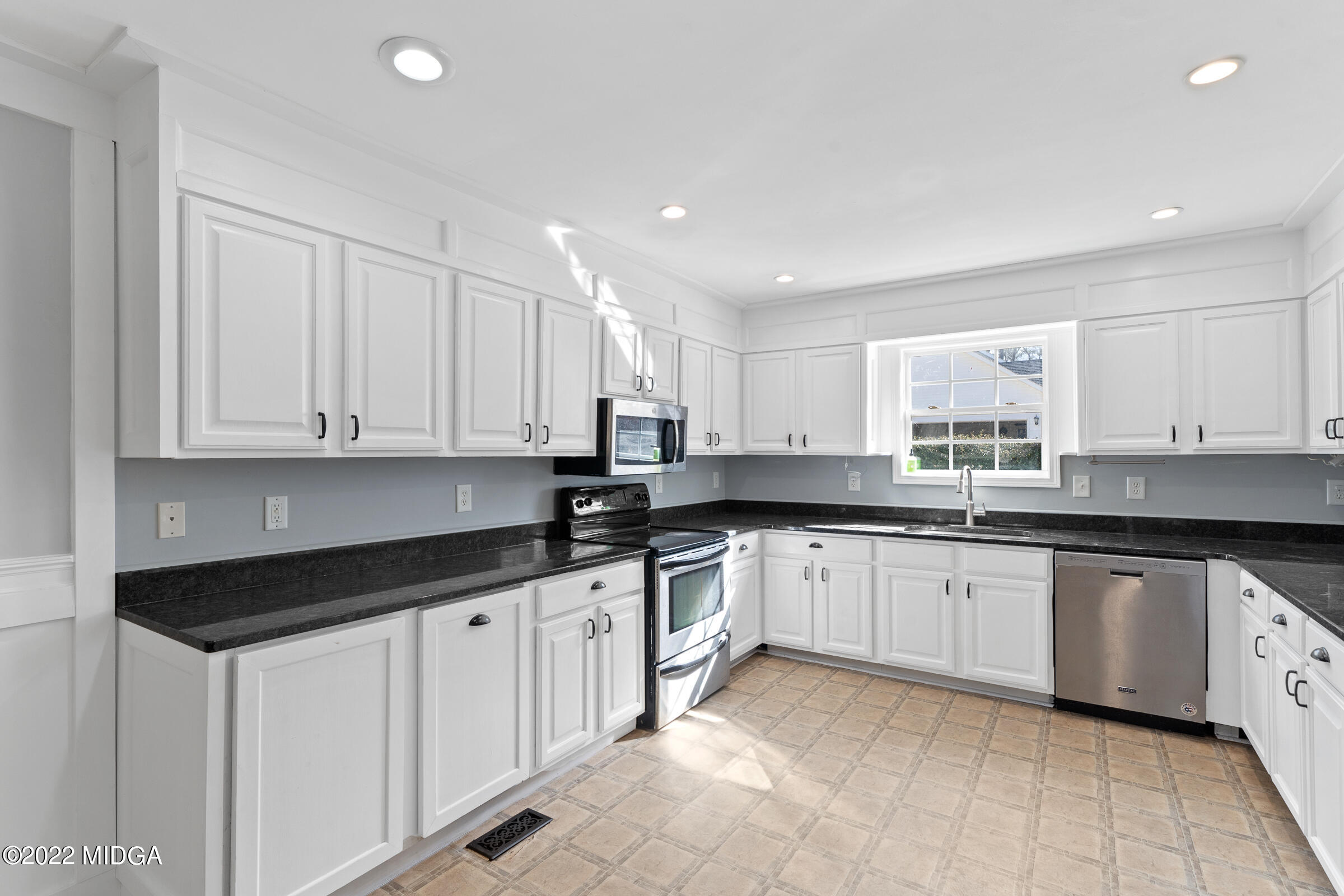 245 Lite-N-Tie Road Gray, GA 31032 - Photo 14 of 29 a kitchen with granite countertop white cabinets white appliances and sink