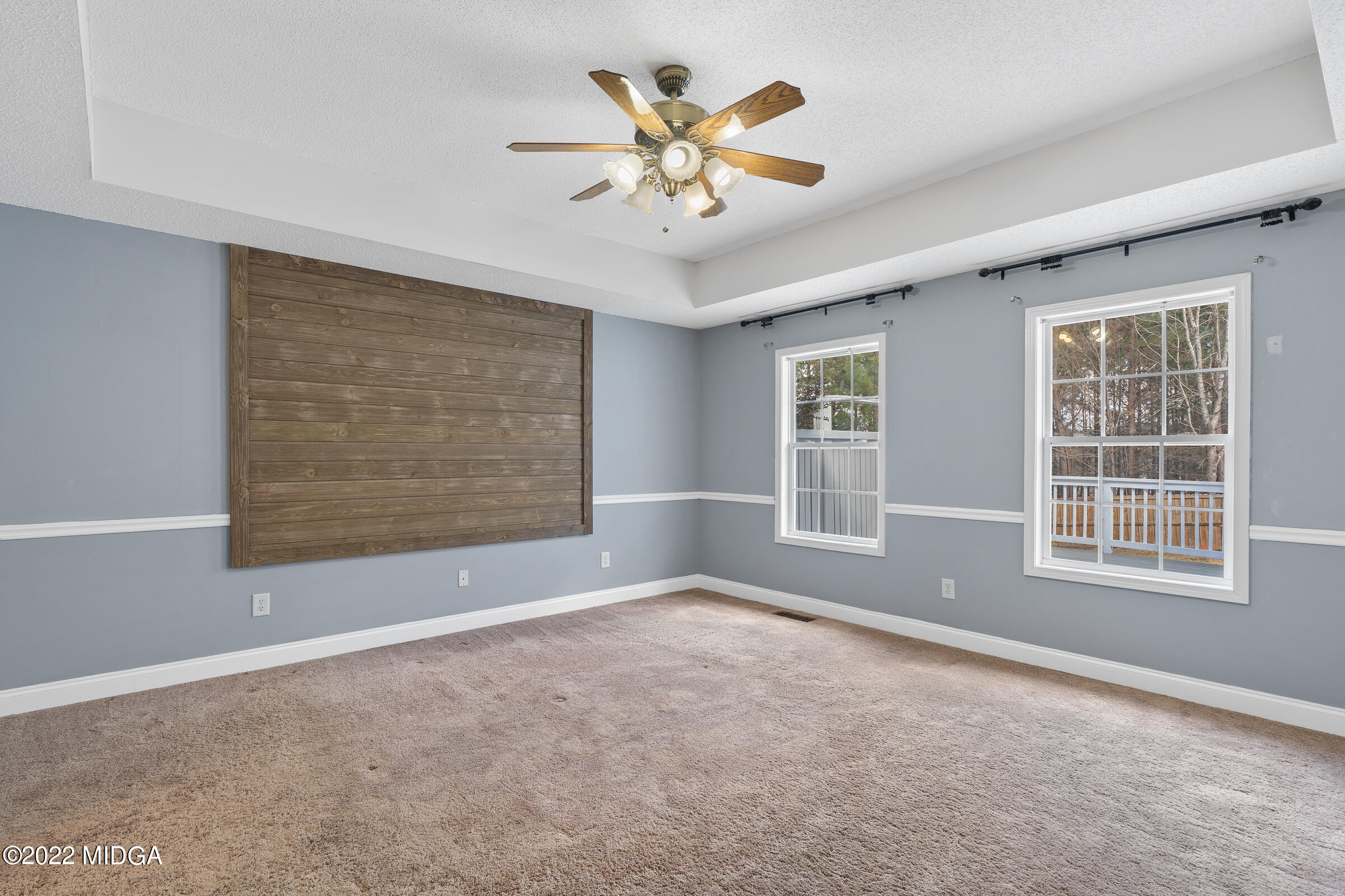 245 Lite-N-Tie Road Gray, GA 31032 - Photo 15 of 29 an empty room with chandelier fan and windows