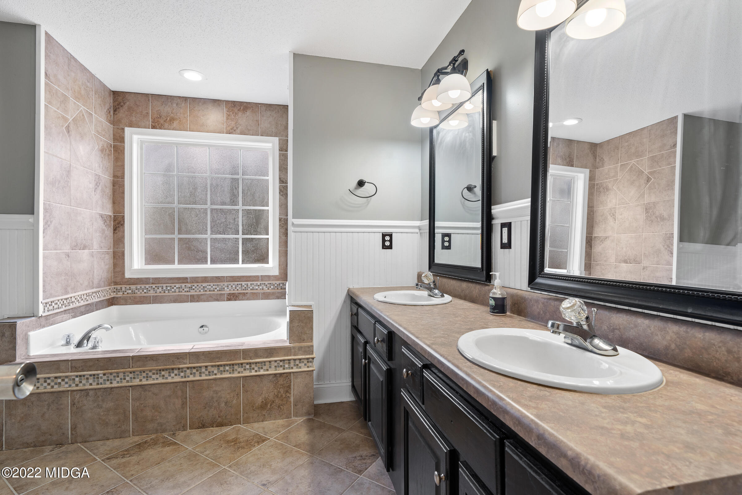 245 Lite-N-Tie Road Gray, GA 31032 - Photo 17 of 29 a bathroom with a granite countertop tub sink and mirror