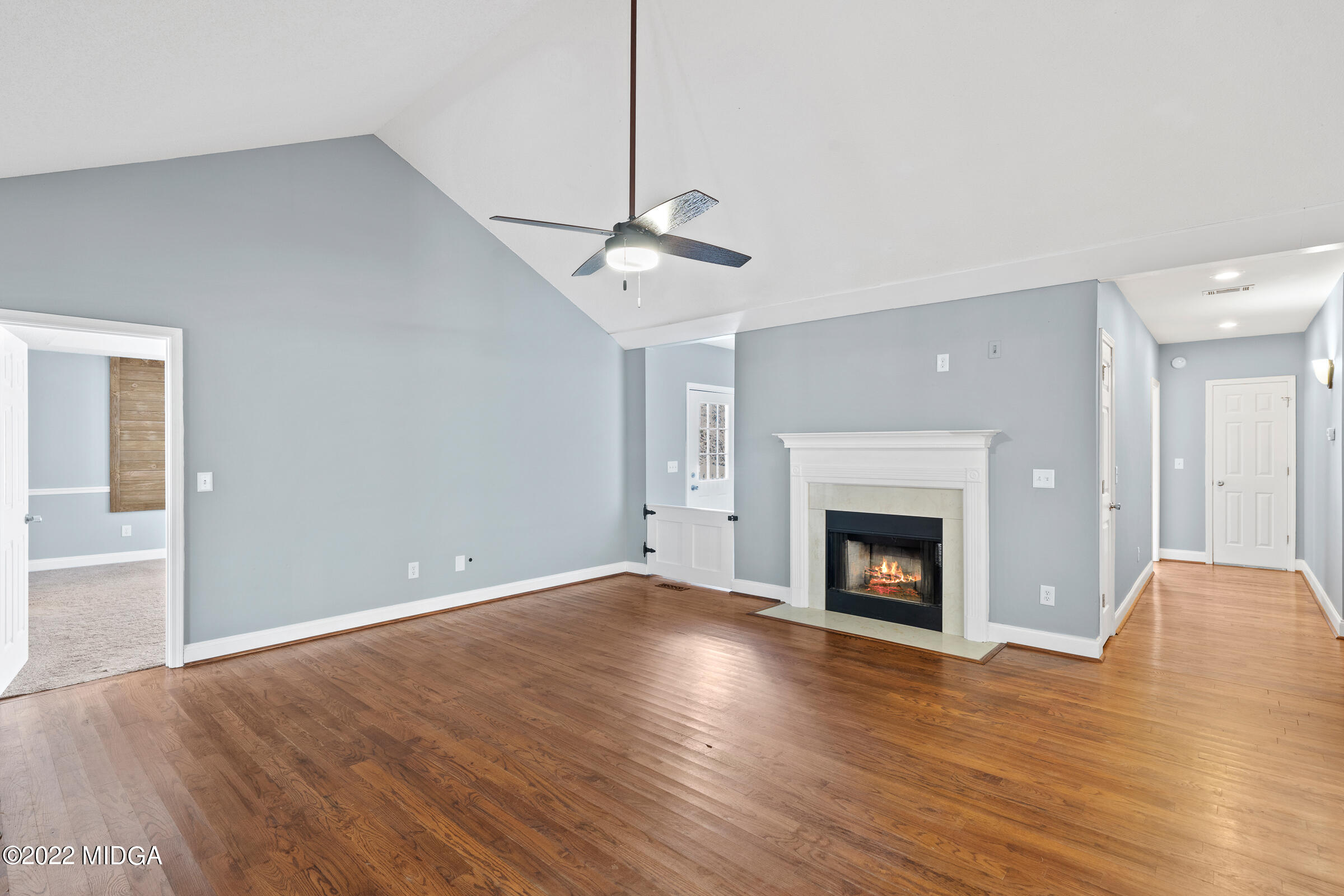 245 Lite-N-Tie Road Gray, GA 31032 - Photo 7 of 29 a view of an empty room with wooden floor fireplace and a window