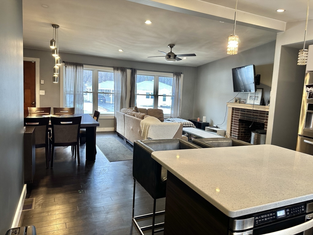 153 Freeman Street Haverhill, MA 01832 - Photo 11 of 31 a living room with stainless steel appliances kitchen island granite countertop furniture and a kitchen view