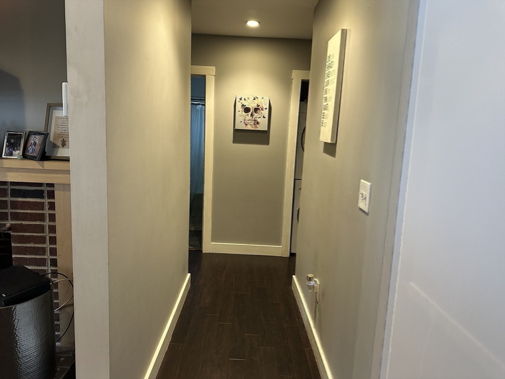 153 Freeman Street Haverhill, MA 01832 - Photo 15 of 31 a view of a hallway with wooden floor and a bathroom