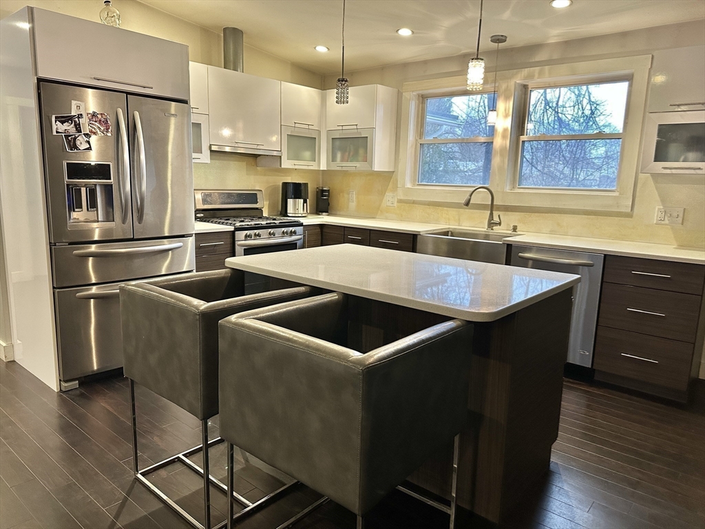 153 Freeman Street Haverhill, MA 01832 - Photo 5 of 31 a kitchen with stainless steel appliances granite countertop a sink a stove a refrigerator and island with wooden floor
