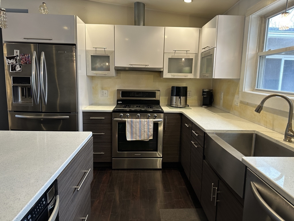 153 Freeman Street Haverhill, MA 01832 - Photo 6 of 31 a kitchen with a sink stove and refrigerator