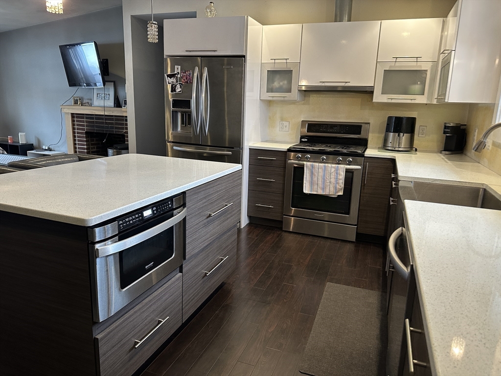 153 Freeman Street Haverhill, MA 01832 - Photo 7 of 31 a kitchen with a stove and a microwave