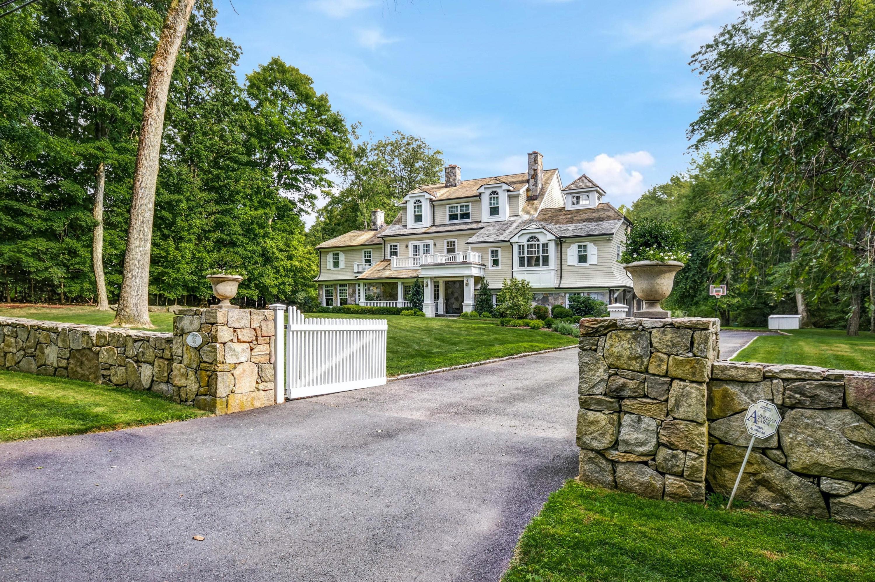 56 Logan Road New Canaan, CT 06840 - Photo 1 of 40 a view of a house with garden and a bench