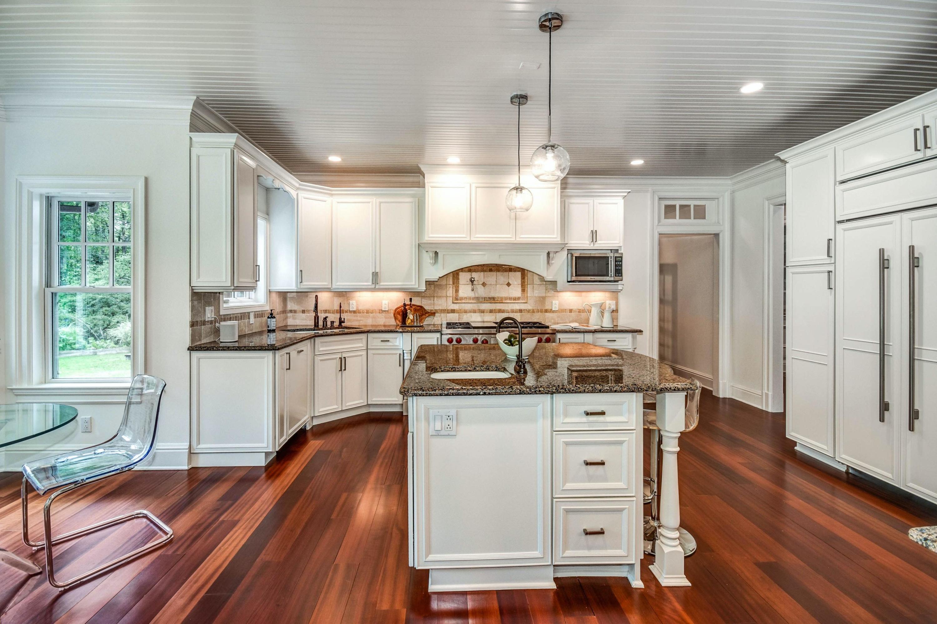 56 Logan Road New Canaan, CT 06840 - Photo 13 of 40 a kitchen with stainless steel appliances granite countertop a stove a sink dishwasher and a refrigerator with wooden floor