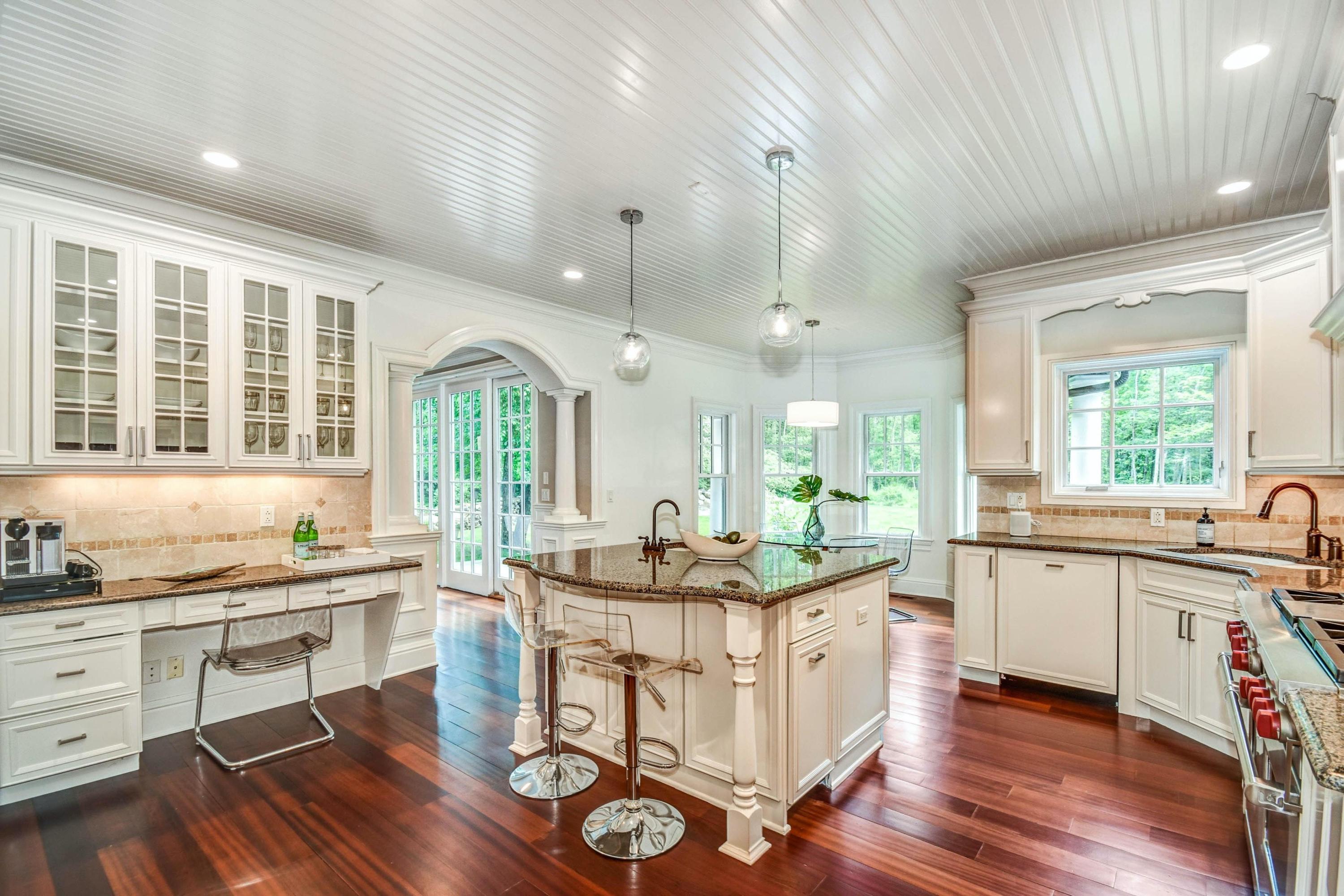 56 Logan Road New Canaan, CT 06840 - Photo 14 of 40 a kitchen with granite countertop a sink and cabinets