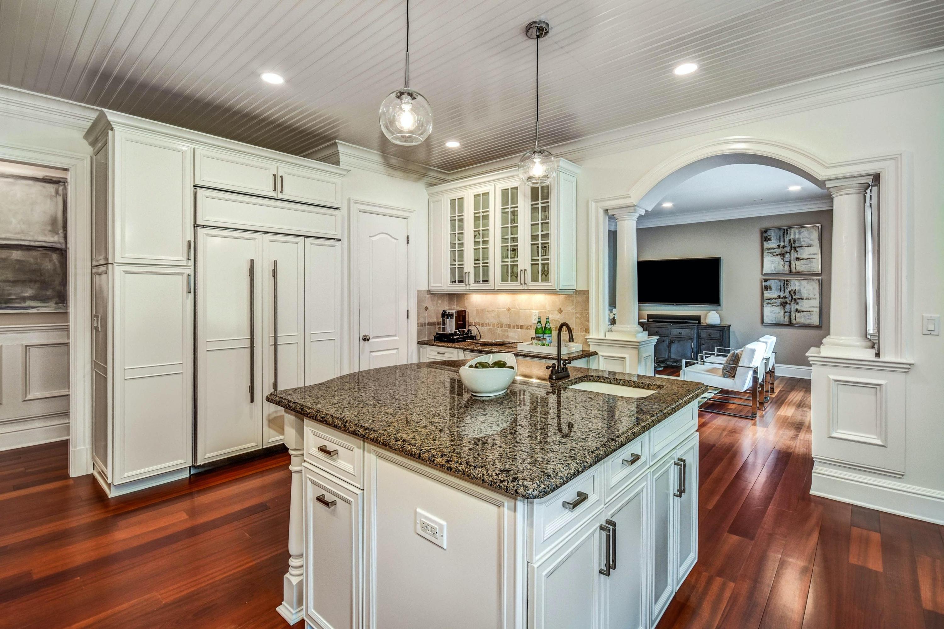 56 Logan Road New Canaan, CT 06840 - Photo 15 of 40 a kitchen with stainless steel appliances granite countertop a sink a stove and a wooden floors