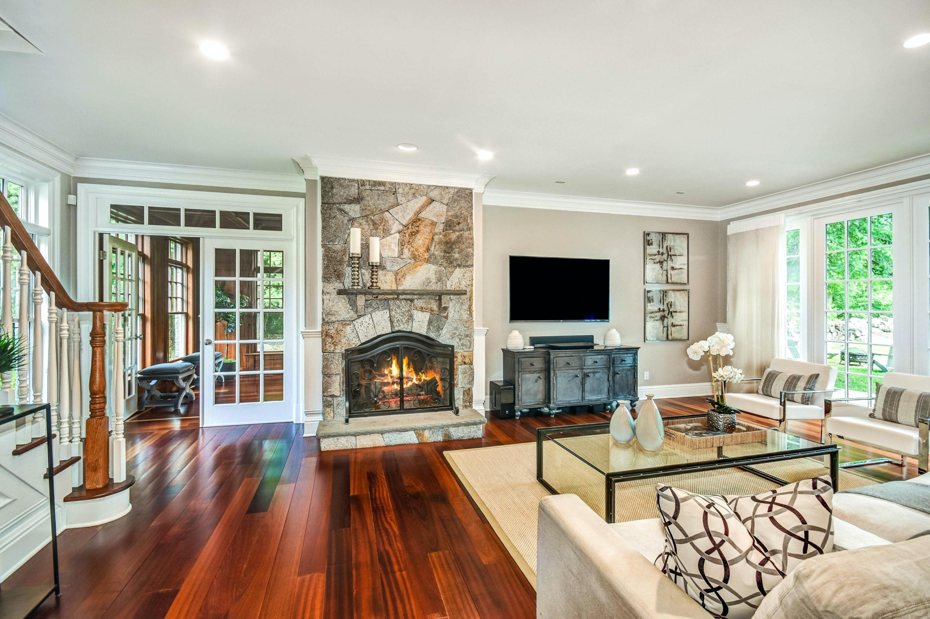 56 Logan Road New Canaan, CT 06840 - Photo 18 of 40 a living room with furniture a flat screen tv and a fireplace