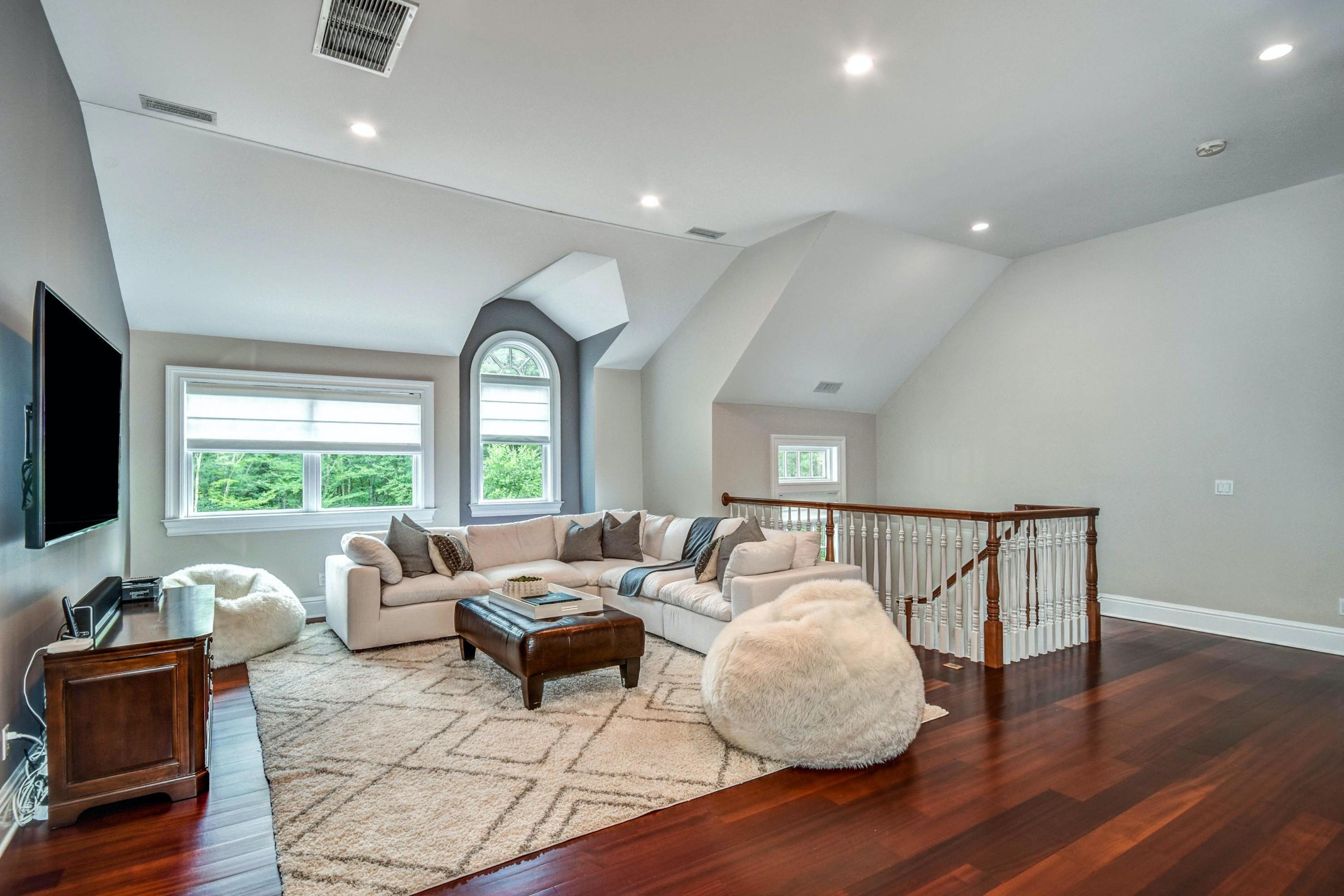 56 Logan Road New Canaan, CT 06840 - Photo 21 of 40 a living room with furniture floor to ceiling window and wooden floor