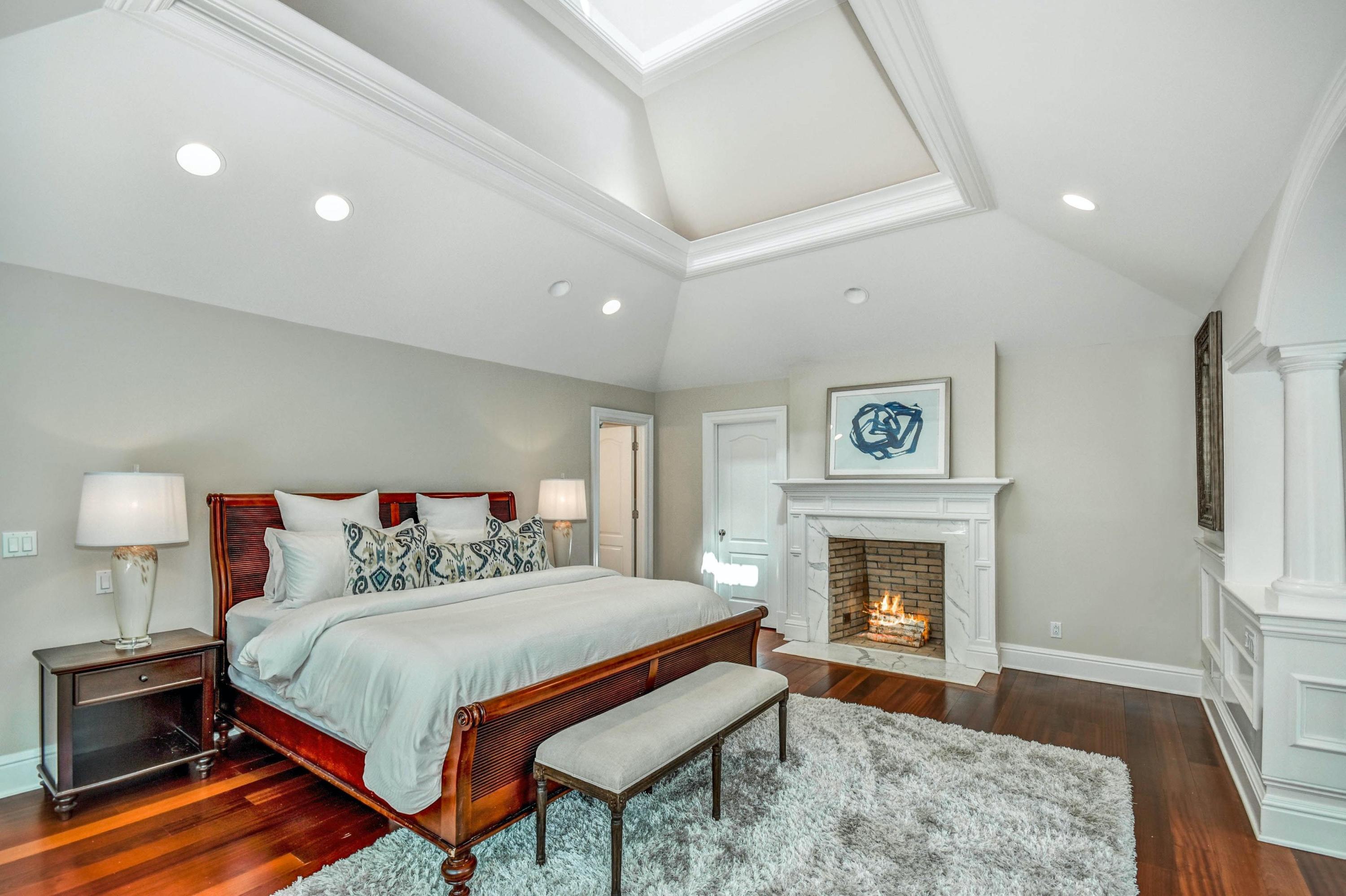56 Logan Road New Canaan, CT 06840 - Photo 26 of 40 a bedroom with a bed and a fireplace