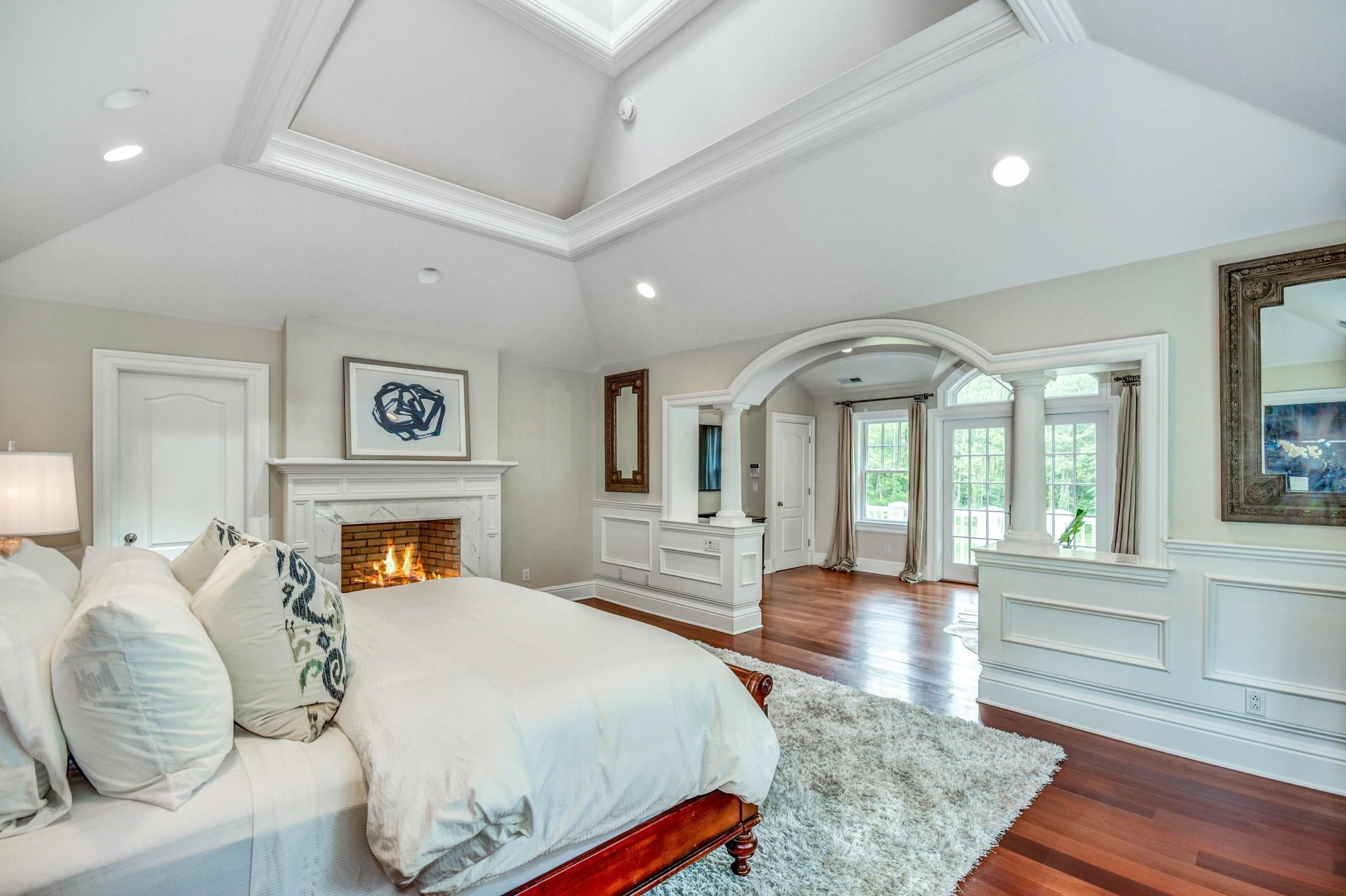 56 Logan Road New Canaan, CT 06840 - Photo 27 of 40 a spacious bedroom with a bed and a couch