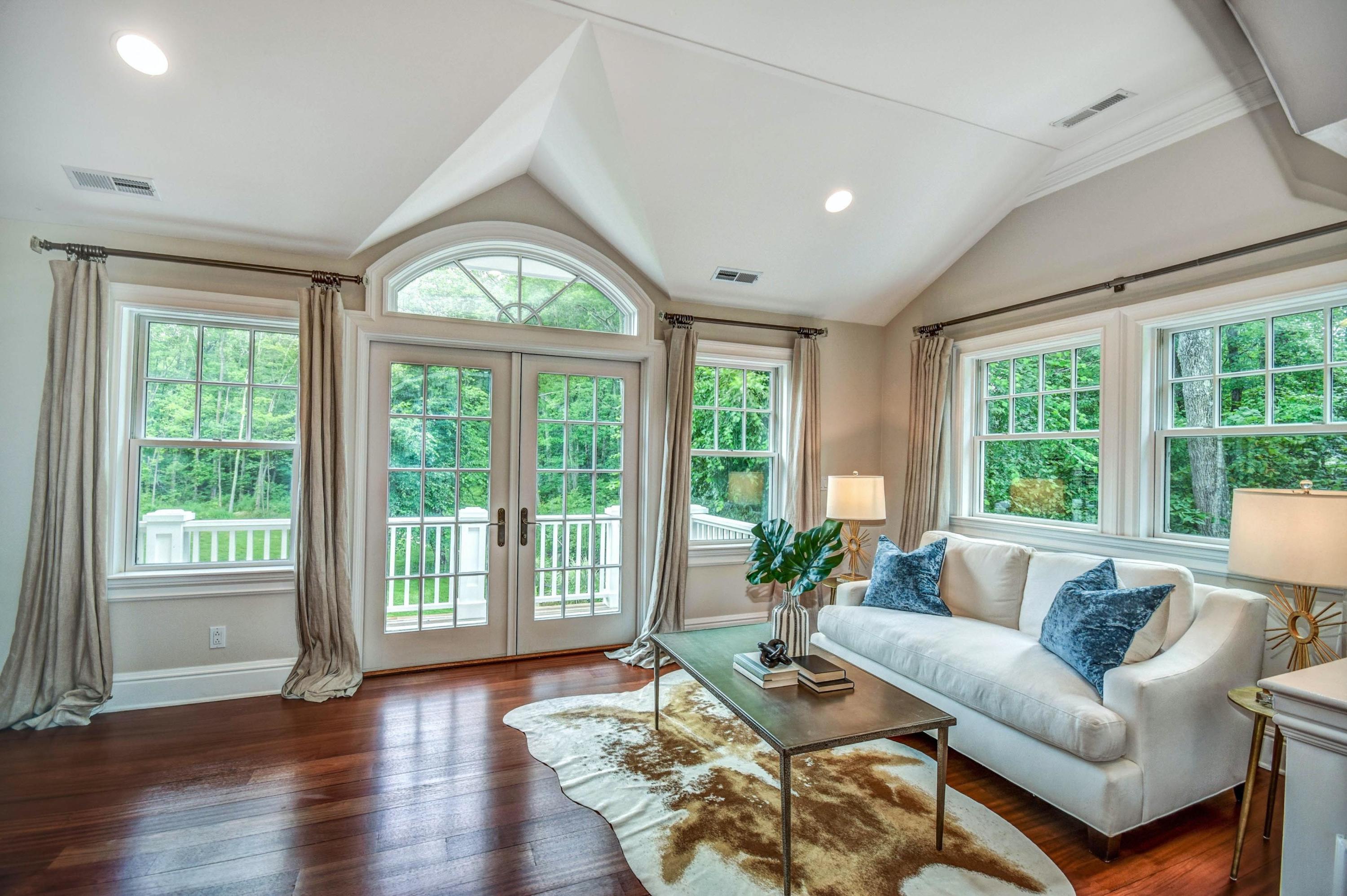 56 Logan Road New Canaan, CT 06840 - Photo 28 of 40 a living room with furniture and a large window